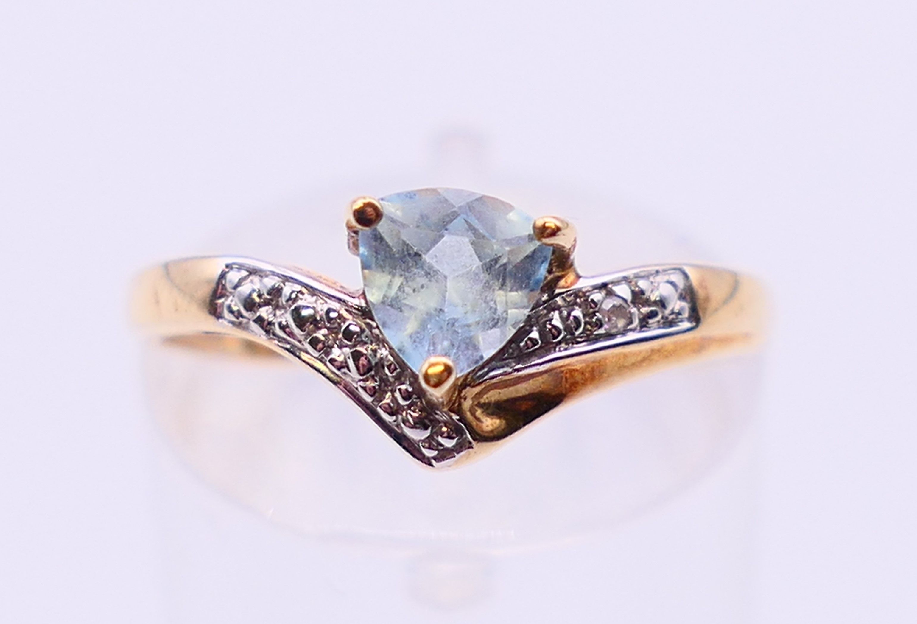A 9 ct gold aquamarine and diamond ring. Ring size N.