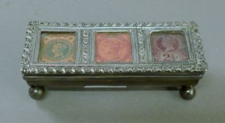 A silver triple stamp box. 9 cm wide.