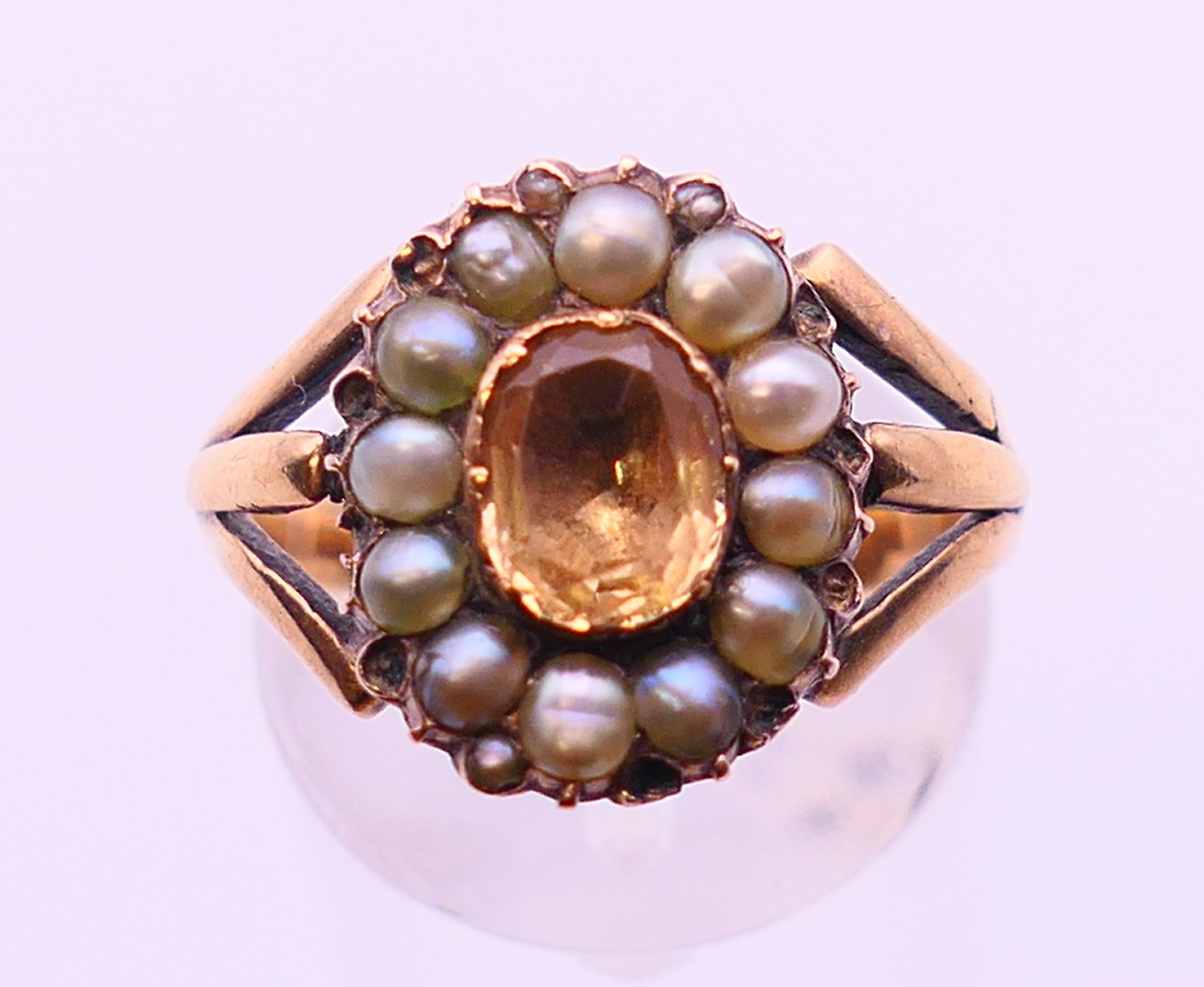 A Georgian unmarked gold Imperial topaz and seed pearl ring. Ring size N.