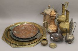 A quantity of Eastern metalware including trays, ewers etc. The largest tray 55 cm wide.