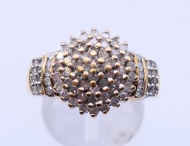 A 9 ct gold diamond cluster ring. Ring size P.