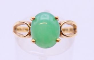 A 14 K gold single stone jade ring. Ring size N/O.