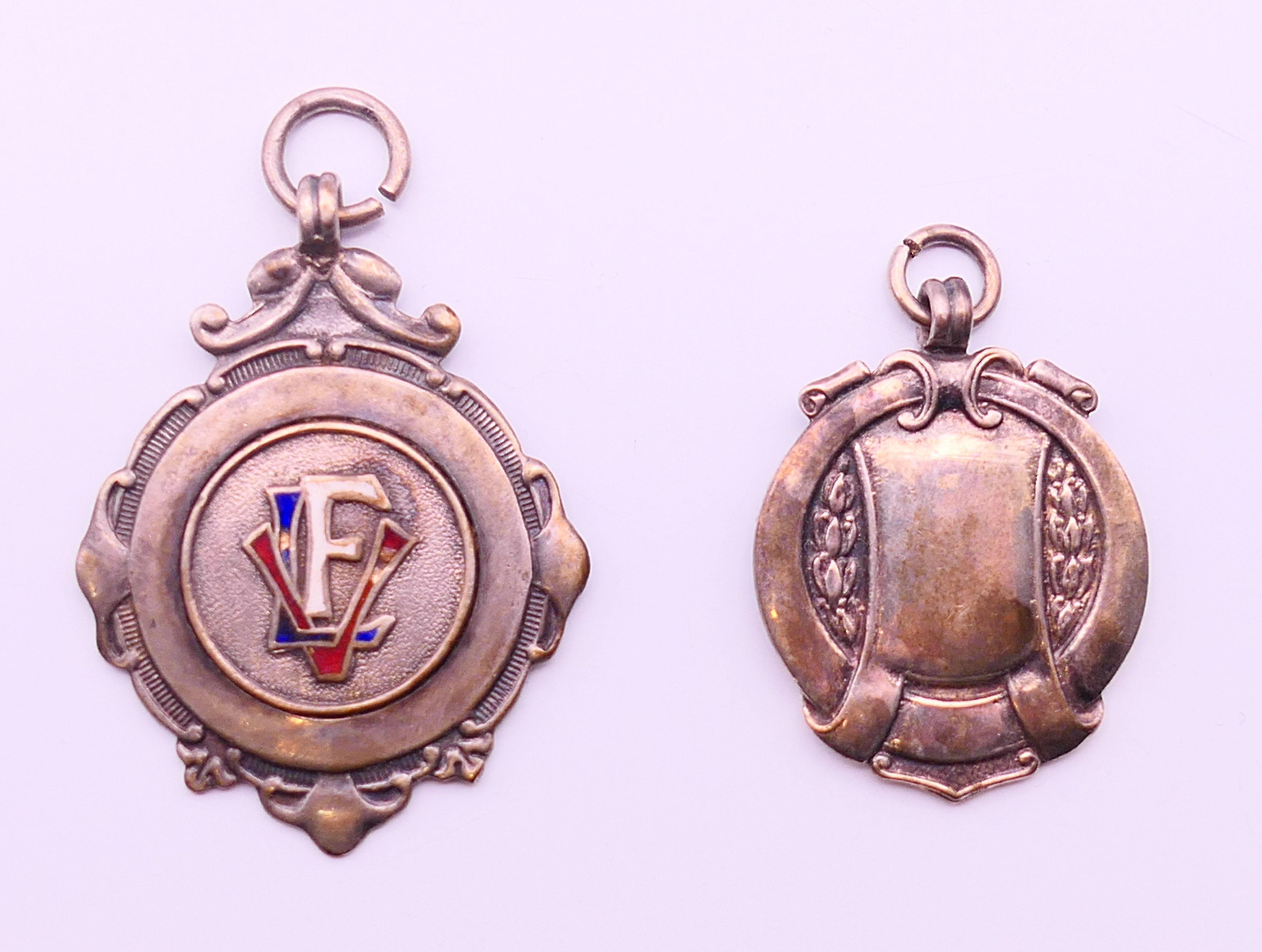 Two silver fobs, one enamel set, one inscribed OPAFC Clapton Cup & WHYOC League W A.