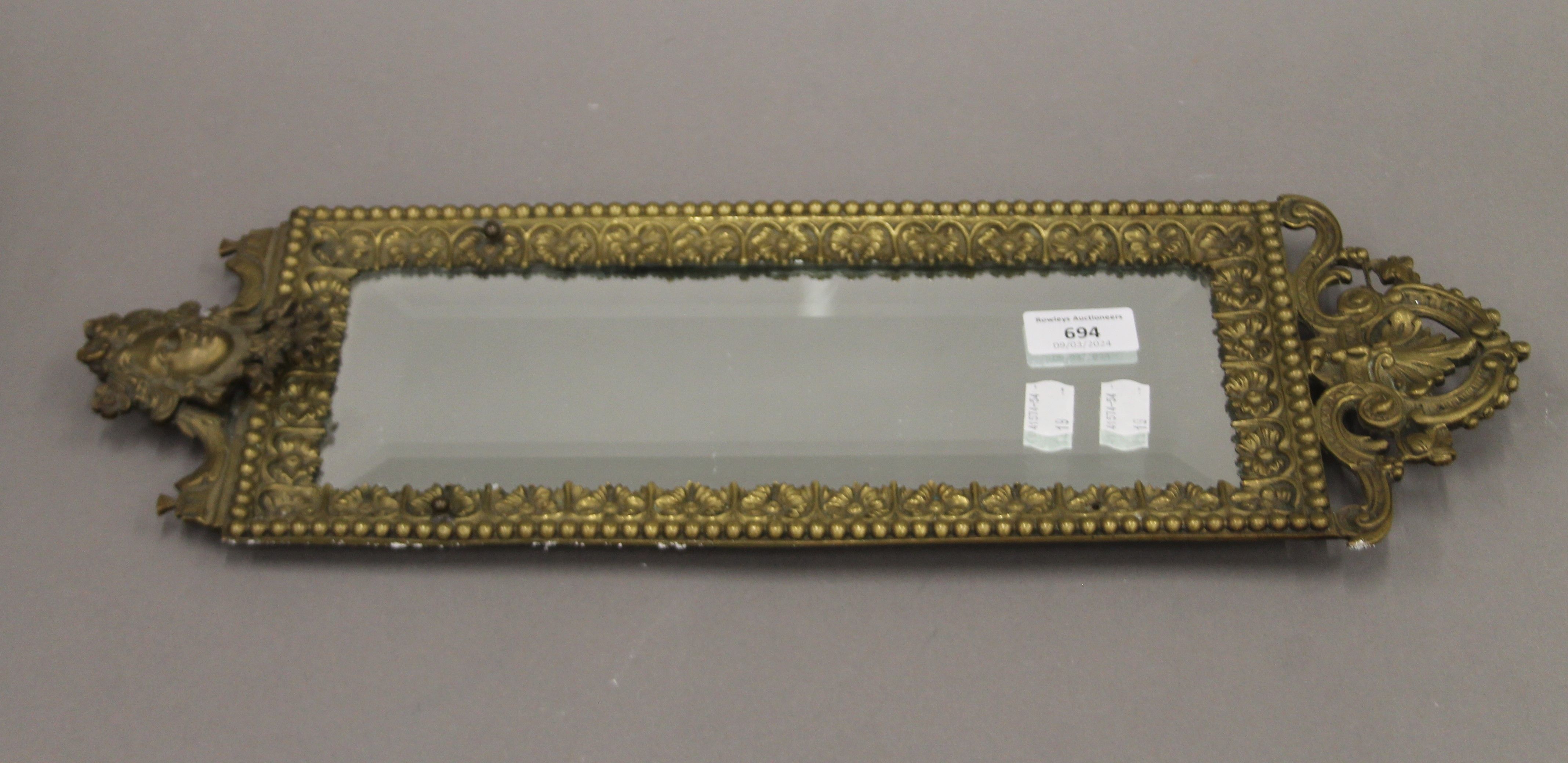 A 19th century brass wall mirror. 49 x 16 cm.