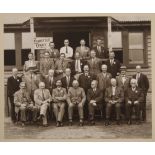 An early 20th century photograph of a committee before a pavilion from the Ely and Cambridge area.