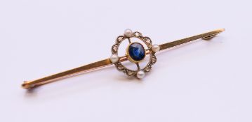 An 15 ct gold diamond, sapphire and seed pearl bar brooch. 6.5 cm long. 3.6 grammes total weight.