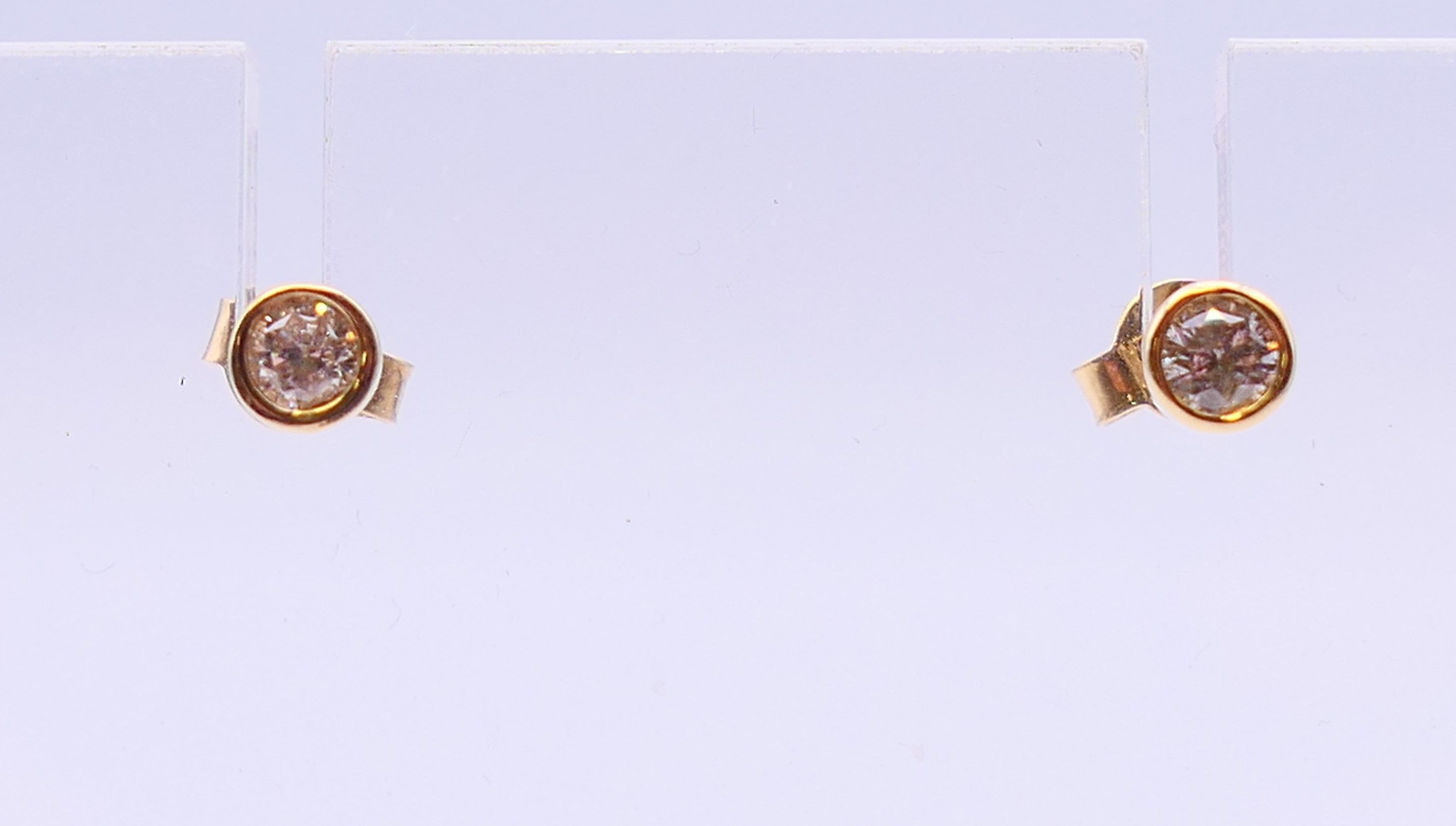 A pair of 9 ct gold diamond earrings. 0.5 ct weight.