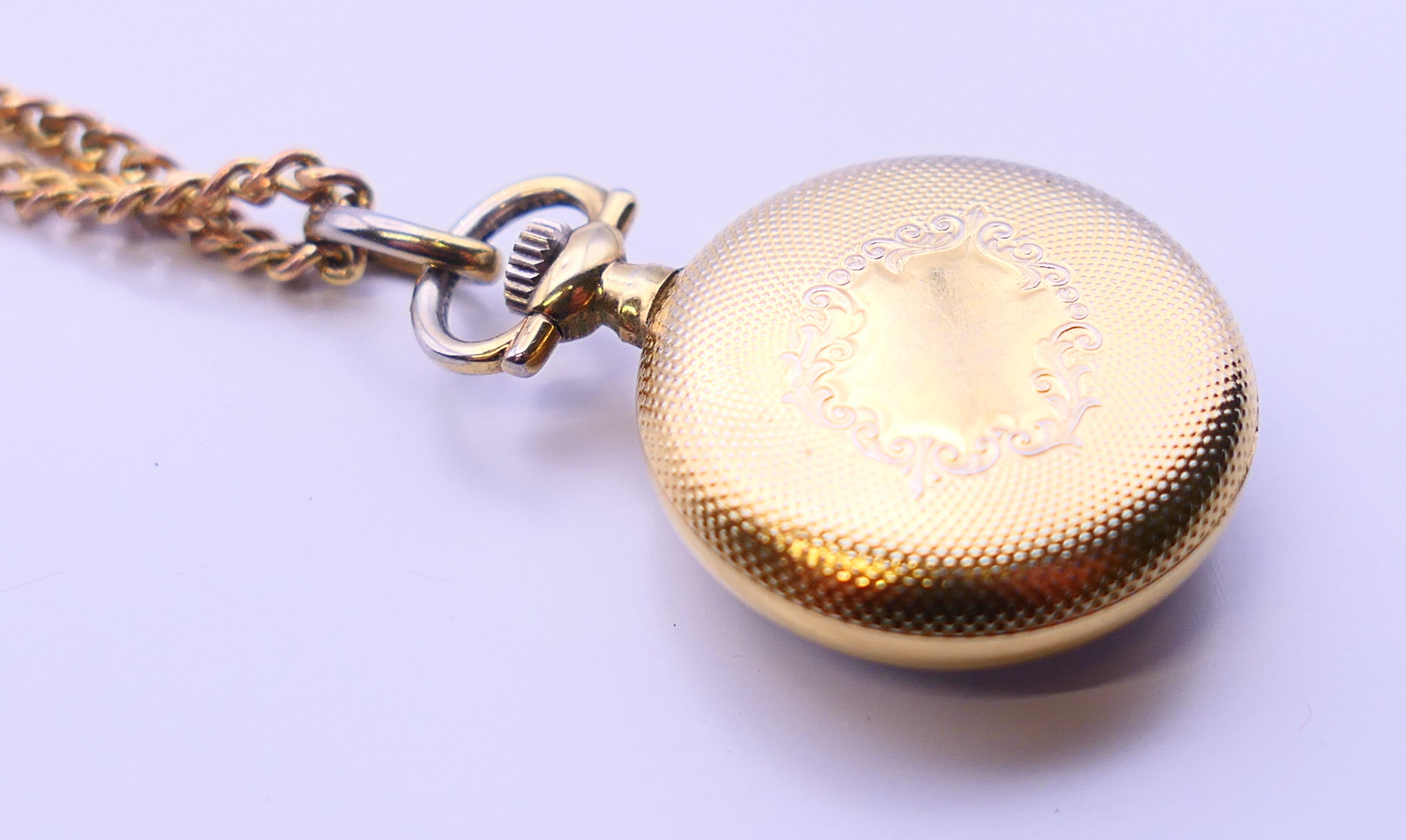 A Rotary fob watch on a 9 ct gold chain. 2.5 cm diameter, chain 62 cm long. The chain 6 grammes. - Image 5 of 8