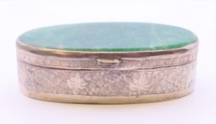 An unmarked eastern white metal box with jade lid. 8.5 cm wide, 2.75 cm high.