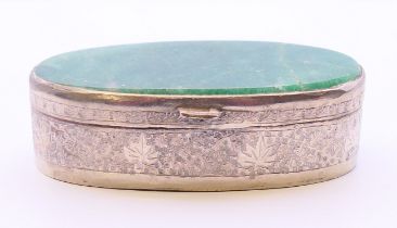 An unmarked eastern white metal box with jade lid. 8.5 cm wide, 2.75 cm high.