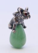 A silver dog on jade pendant. 3 cm high.