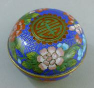 A round cloisonne box. 8 cm diameter.