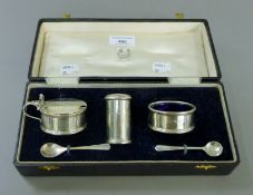 A cased silver cruet set. The case 25 cm wide. 5.3 troy ounces.