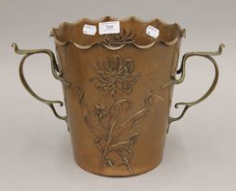 An Arts and Crafts copper and brass ice bucket, the base bearing mark of CDE between crossed swords.