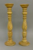 A pair of wooden pricket sticks. 52 cm high.