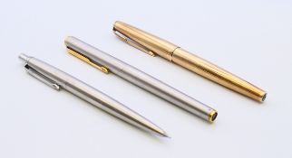 Two Parker fountain pens (one 9 ct gold clad) and a Parker ballpoint pen.