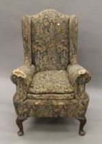 An early 20th century wing back armchair. 80 cm wide.