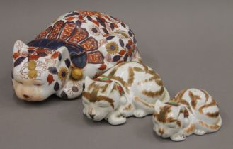 Three porcelain cats. The largest 30 cm long.