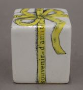 A Fornasetti porcelain desk weight formed as a wrapped present. 6.
