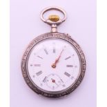 A silver pocket watch. 4 cm diameter.