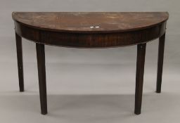 A 19th century mahogany demi-lune side table. 130 cm wide.