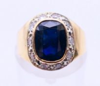 A 14 K gold diamond and sapphire ring. Ring size H.