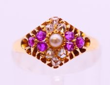 An antique 18 ct gold ruby, diamond and pearl ring, assayed Birmingham 1876. Ring size L.