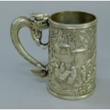 A Chinese silver embossed tankard with dragon-form handle. 11.5 cm high. 7.9 troy ounces.