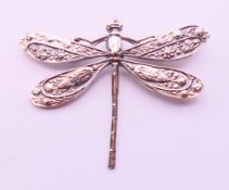 A small silver dragonfly brooch. 5 cm x 4 cm.