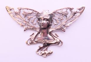 A large silver pierced Art Nouveau style girl form brooch. 7.5 cm x 5 cm.