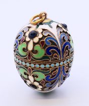 A large silver and enamel egg pendant bearing Russian marks. 3.5 cm high.