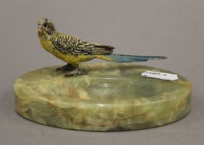 A cold-painted bronze budgie mounted on an onyx ashtray. 12 cm long overall.