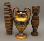 A colourful Egyptian decorative urn-shaped twin-handled vase together with two wooden vases. 41.