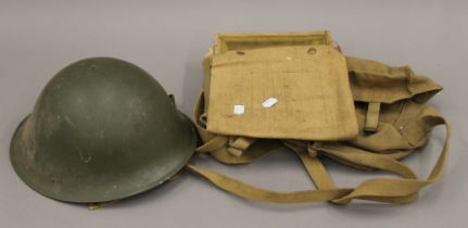 A British Army tin helmet, webbing map case and shoulder bag.