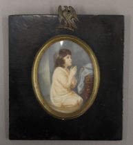 A 19th century miniature portrait on ivory of a young girl praying, framed and glazed. 13 x 14 cm.