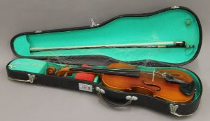 A cased violin and bow. The former 58 cm long.