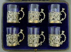 A cased set of silver-mounted tot glasses. Each 5 cm high.