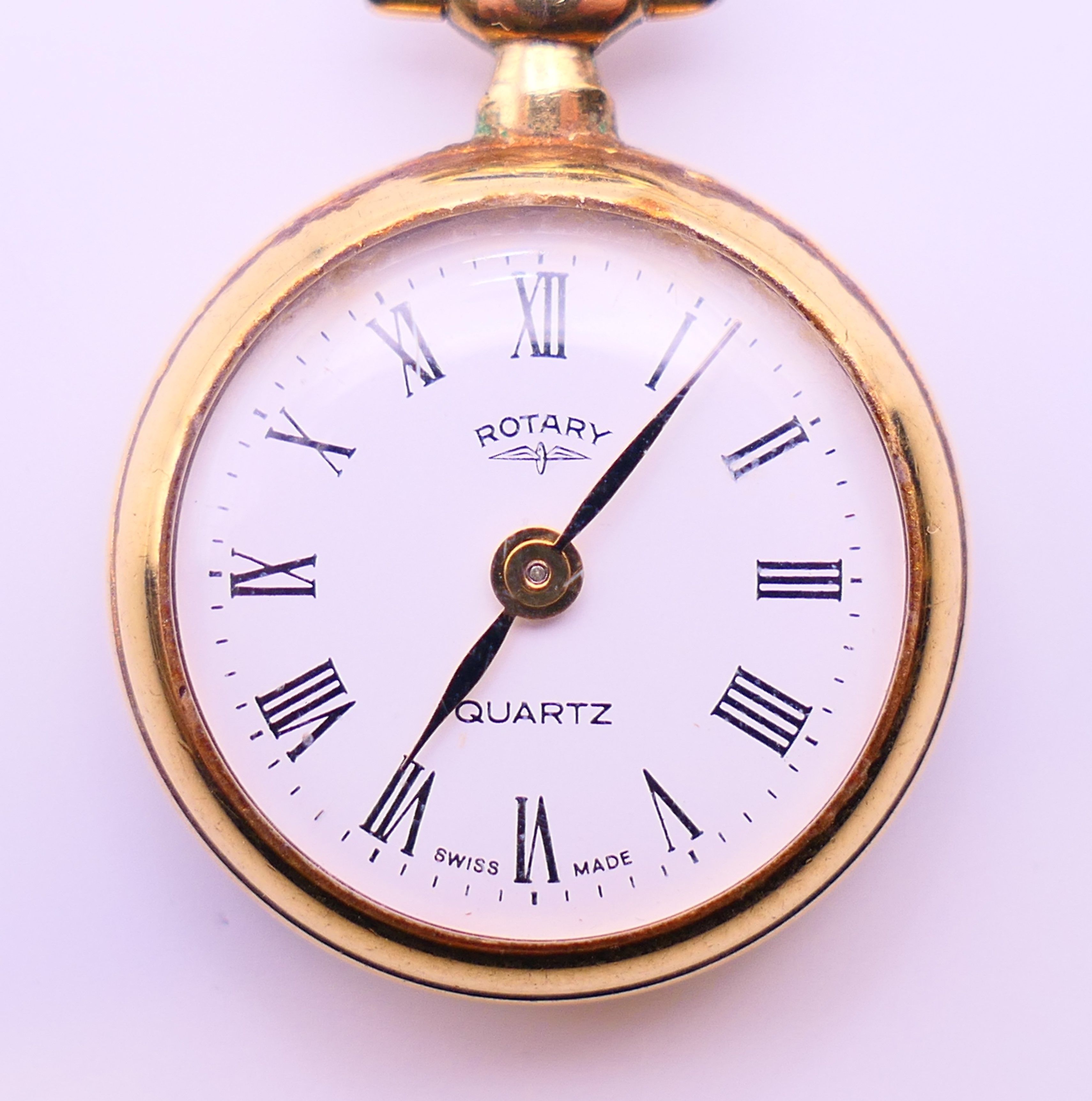 A Rotary fob watch on a 9 ct gold chain. 2.5 cm diameter, chain 62 cm long. The chain 6 grammes. - Image 3 of 8