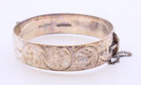 A silver hallmarked engraved bracelet. 6 cm inner diameter.