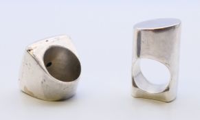 Two unmarked silver modernist rings, the largest 3.5 cm high. Ring size each P/Q. 67.8 grammes.