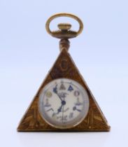 A brass Masonic style watch. 6 cm high.
