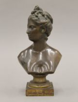 A patinated bronze female bust. 22 cm high.
