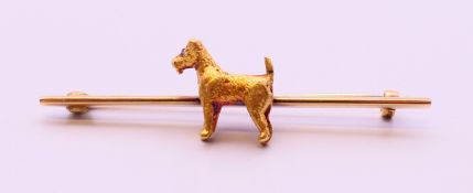 A 9 ct gold dog form bar brooch. 5 cm long. 5.7 grammes.