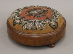 A Victorian bead work footstool. 27.5 cm diameter.