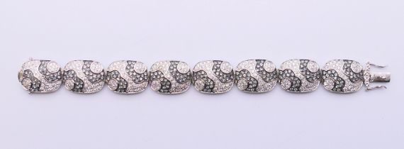A silver, cubic zirconia and black stone bracelet. 20 cm long.