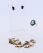 A collection of silver jewellery, to include a charm bracelet, a ring and a pair of earrings.