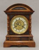 A 19th century walnut mantle clock. 37 cm high.