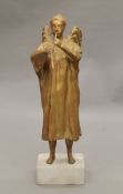 A gilt-painted sculpture of an angel mounted on a composite stone plinth base. 105 cm high.
