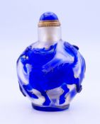 A blue Peking glass snuff bottle and stopper. 8 cm high.