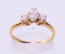 A 14 K gold marquise and round cut three stone ring. Ring size O.